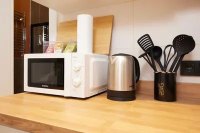 a microwave sitting on top of a kitchen counter at Charming 3BR 2Bath AC in Center - Santur D2 in Istanbul