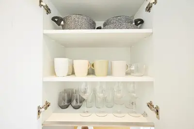 a shelf with wine glasses and bowls on it at Stunning 3BR 2Bath AC in Center - Santur D3 in Istanbul