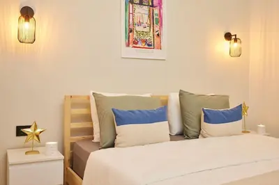 a bedroom with a bed with blue and white pillows at Stunning 3BR 2Bath AC in Center - SanturD4 in Istanbul