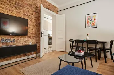 a living room with a brick wall and a table and chairs at Stunning 3BR 2Bath AC in Center - SanturD4 in Istanbul
