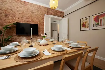 a dining room table with chairs and a television at Spacious 6BR 3Bath AC in Center - Santur D5-6 in Istanbul