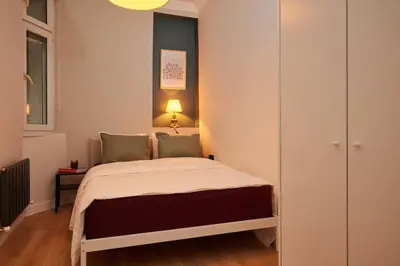 a small bedroom with a bed with a lamp on it at Spacious 6BR 3Bath AC in Center - Santur D5-6 in Istanbul