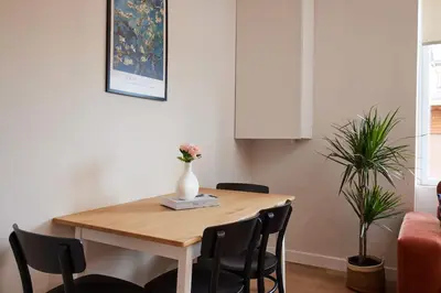 a dining room table with a vase of flowers on it at Charming 3BR 2Bath AC in Center - Santur D7 in Istanbul