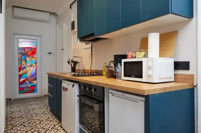 a kitchen with blue cabinets and a white microwave at Charming 3BR 2Bath AC in Center - Santur D7 in Istanbul