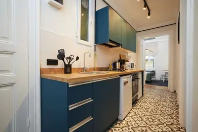 a kitchen with blue cabinets and a tile floor at Charming 3BR 2Bath AC in Center - Santur D7 in Istanbul