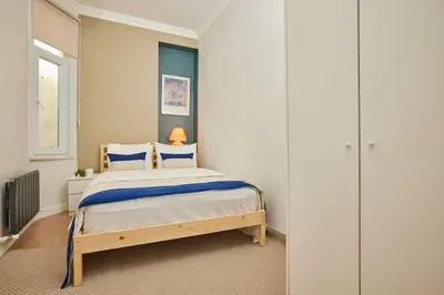 a bedroom with a large bed with blue accents at Charming 3BR 2Bath AC in Center - Santur D8 in Istanbul