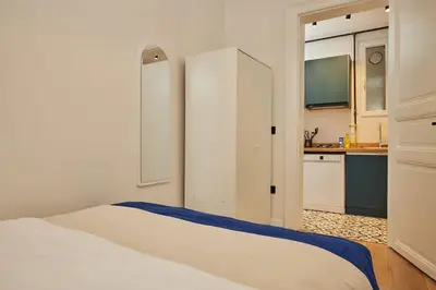 a bedroom with a white bed and a kitchen at Charming 3BR 2Bath AC in Center - Santur D8 in Istanbul