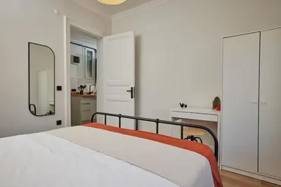 a white bedroom with a bed and a mirror at Spacious 3BR 2Bath AC in Center - Santur D9 in Istanbul