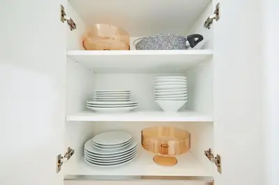 a cupboard filled with white plates and dishes at Spacious 3BR 2Bath AC in Center - Santur D9 in Istanbul
