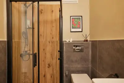 a bathroom with a toilet and a glass shower door at Spacious 3BR 2Bath AC in Center - Santur D9 in Istanbul