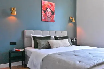 a bedroom with a large bed with a painting on the wall at Cozy Renovated 3BR near Taksim- Santur D10 in Istanbul