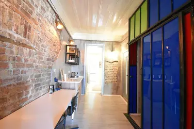a kitchen with a brick wall and colorful glass doors at Stunning 6BR 4Bath near Tram in Istanbul