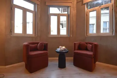 two chairs and a table in a room with windows at Stunning 6BR 4Bath near Tram in Istanbul