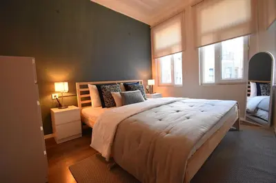 a bedroom with a large bed and two windows at Stunning 6BR 4Bath near Tram in Istanbul