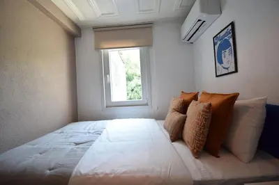 a bedroom with a large white bed with a window at Stunning 6BR 4Bath near Tram in Istanbul