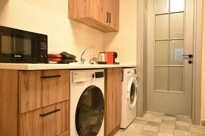 a kitchen with a washing machine and a microwave at Stunning 6BR 4Bath near Tram in Istanbul