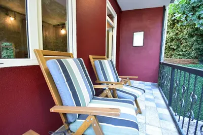 two chairs sitting on a porch next to a window at Stunning 6BR 4Bath near Tram in Istanbul