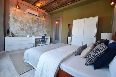 a bedroom with a large white bed and a bathroom at Stunning 6BR 4Bath near Tram in Istanbul