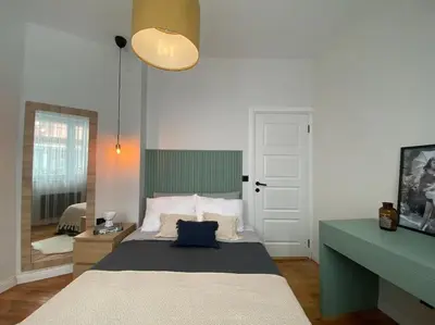 a bedroom with a bed with a green and white at Stunning Apartment Near Metro - Değirmen 64 in Istanbul