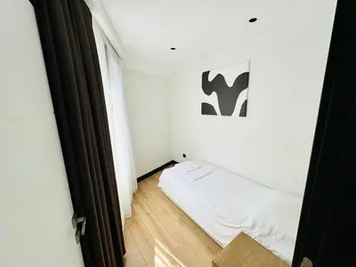 a small room with a white bed and a window at Rose Point Residence in Istanbul