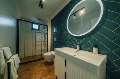 a bathroom with a sink and a mirror and a toilet at Sapanca İnci Suit in Yanık