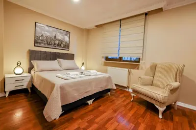 a bedroom with a bed and a chair at Boğaz Manzaralı Havuzlu Lüks Villa in Istanbul