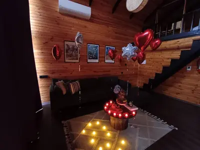 a living room with a couch and a table with balloons at THEA Sapanca Bungalov in Dilekli