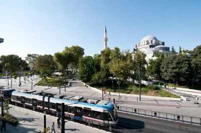 a blue and white train on a city street at XLoft in Istanbul