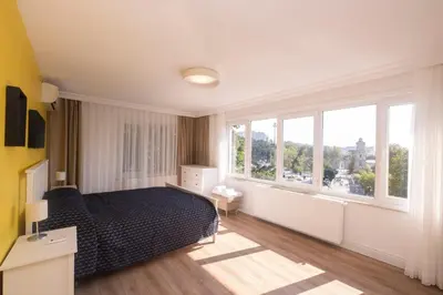 a bedroom with a bed and a large window at Contemporary Waterfront Apt with a Stunning View in Istanbul