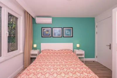 a bedroom with a bed and two tables with lamps at Contemporary Waterfront Apt with a Stunning View in Istanbul