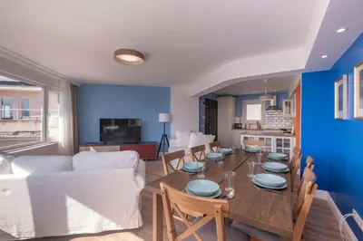 a dining room and living room with a table and a couch at Contemporary Waterfront Apt with a Stunning View in Istanbul