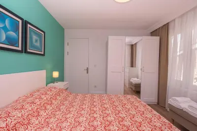 a bedroom with a bed and a blue wall at Contemporary Waterfront Apt with a Stunning View in Istanbul
