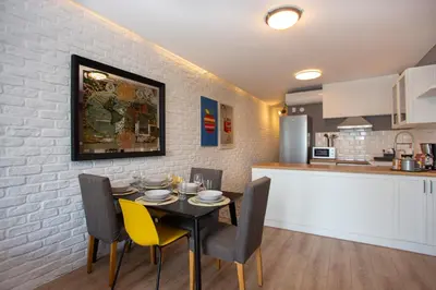 a kitchen and dining room with a table and chairs at Waterfront Apartments with a Stunning View in Istanbul