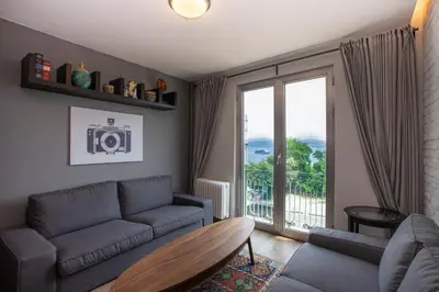 a living room with a couch and a balcony at Waterfront Apartments with a Stunning View in Istanbul