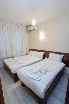 two beds sitting next to each other in a room at Marmara Apartments in Istanbul