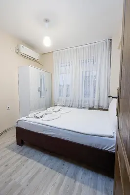 a large bed in a room with a window at Marmara Apartments in Istanbul