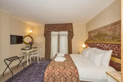 a hotel room with a bed and a desk at By Murat Royal Hotel Galata in Istanbul