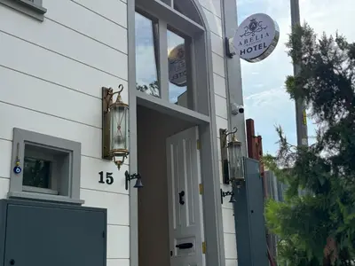 a door to a building with a sign on it at Abelia Mansion Hotel in Istanbul