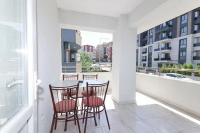 a balcony with a table and chairs on it at PARADİSE pansiyon otel in Nilüfer