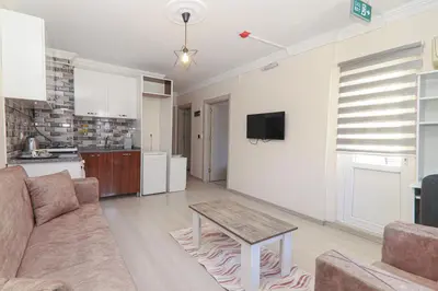 a living room with a couch and a table at PARADİSE pansiyon otel in Nilüfer