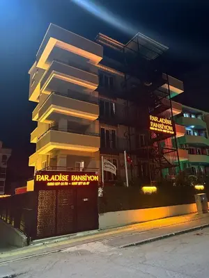 a tall building with a sign in front of it at PARADİSE pansiyon otel in Nilüfer