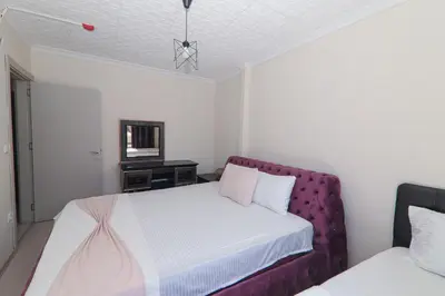 a bedroom with a bed and a purple couch at PARADİSE pansiyon otel in Nilüfer