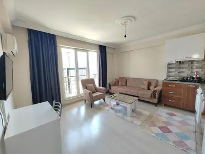 a living room with a couch and a table at PARADİSE pansiyon otel in Nilüfer