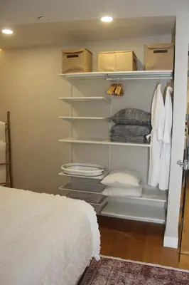 a closet with white shelves and a bed at Lovely One Bedroom Appartment-530 in Istanbul
