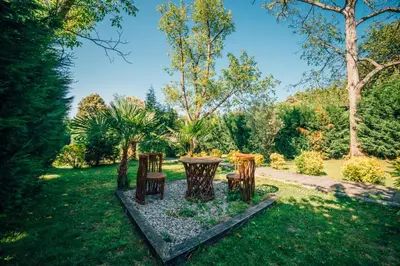 a table and chairs in the grass in a yard at MC Sapanca Hotel in Sakarya