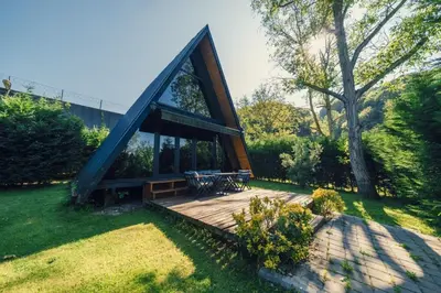 a house with a wooden deck in a yard at MC Sapanca Hotel in Sakarya