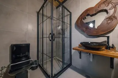 a glass shower in a bathroom with a toilet at MC Sapanca Hotel in Sakarya