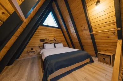 a bedroom with a bed in a wooden cabin at MC Sapanca Hotel in Sakarya