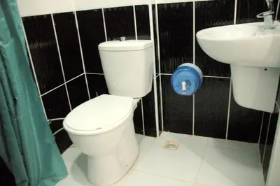 a bathroom with a toilet and a sink at Tolga Hotel in Istanbul