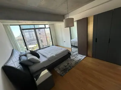 a bedroom with a bed and a large window at Enjoy luxury family apt in Istanbul